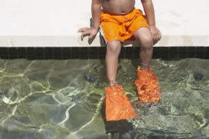 Young boy wearing flippers in a swimming pool